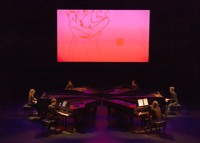 Grand Band performing on six grand pianos